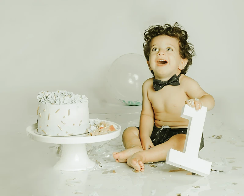 Baby boy tender smile for his 1st birthday photo shoot